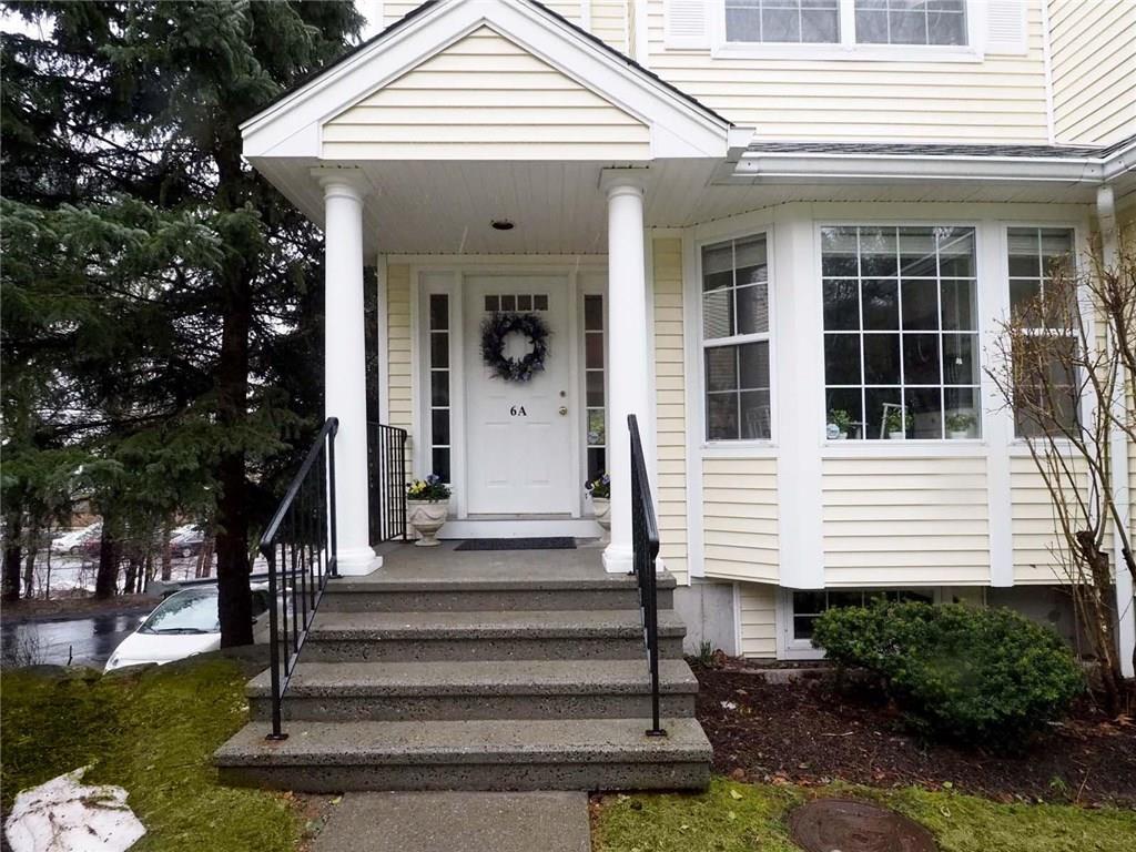 180 Turn Of River Road, Unit 6A Stamford, CT 06905 - Photo 1 of 1 a front view of a house with a garden