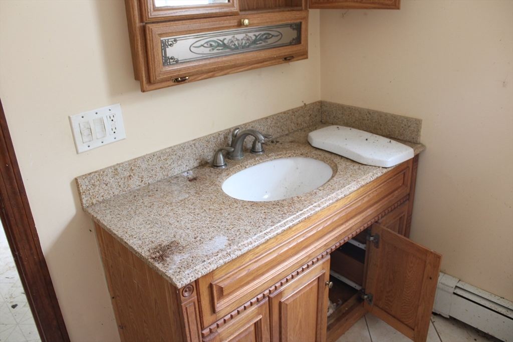 3 Ledge Street Sutton, MA 01590 - Photo 6 of 12 a bathroom with a granite countertop sink and a mirror
