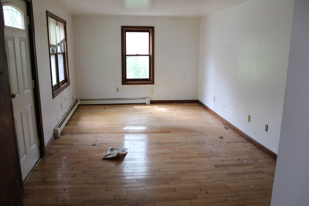 3 Ledge Street Sutton, MA 01590 - Photo 8 of 12 an empty room with wooden floor and windows