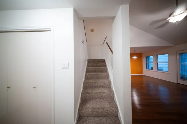 a view of a hallway with wooden floor and entryway