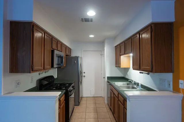 a kitchen with granite countertop a sink and a stove