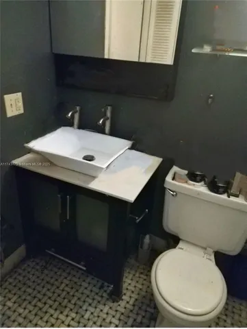 a bathroom with a sink a toilet and a mirror