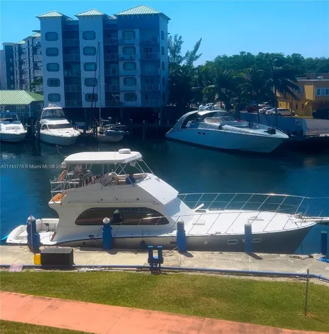 a front view of a house with lake view and a fountain