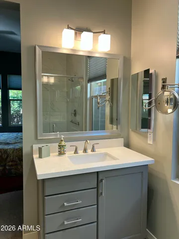 a bathroom with a sink and a mirror