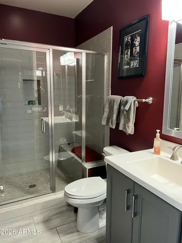 a bathroom with a toilet sink and shower