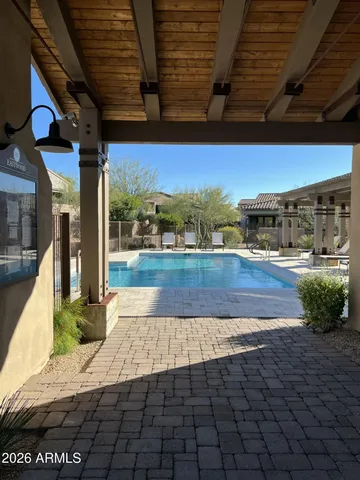 a view of a swimming pool with an outdoor seating