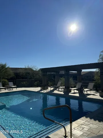 a view of a swimming pool and an outdoor seating