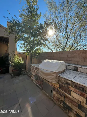 a view of a backyard with furniture and a fire pit