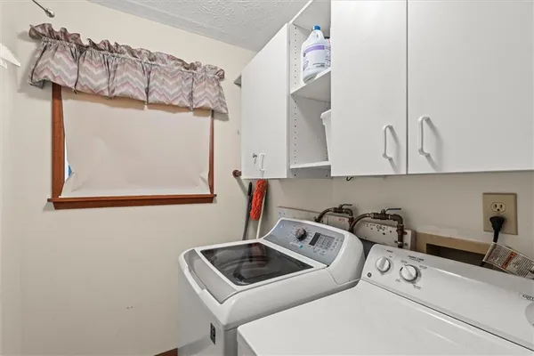 a utility room with sink dryer and washer