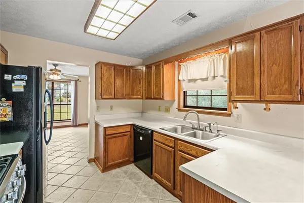 a kitchen with a sink stove and cabinets