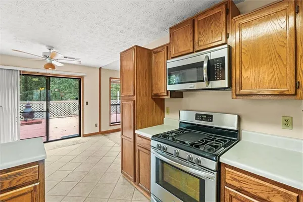 a kitchen with stainless steel appliances granite countertop a stove and a microwave