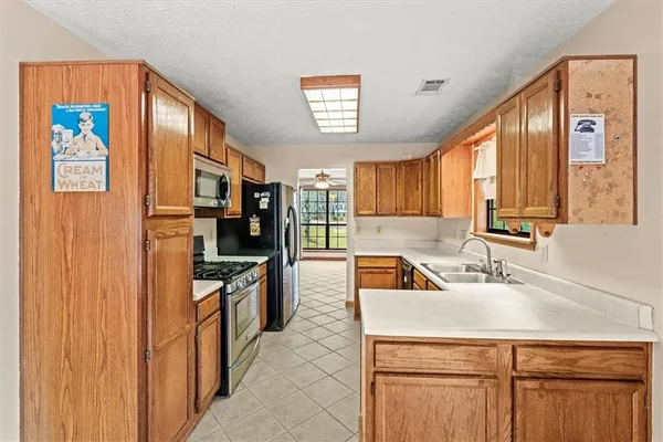 a kitchen with stainless steel appliances a stove a sink and a refrigerator