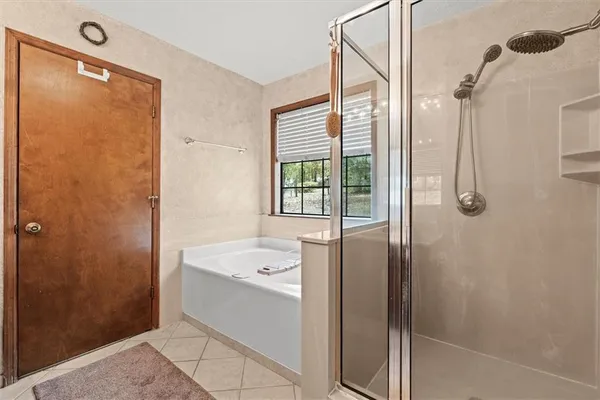 a bathroom with a tub shower and sink