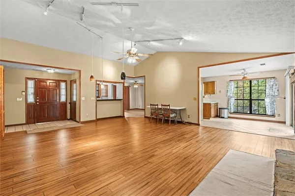a view of a livingroom with furniture wooden floor and windows