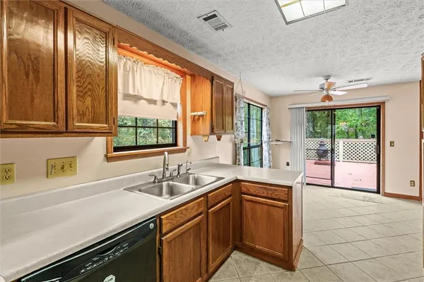 a kitchen with a sink and large window