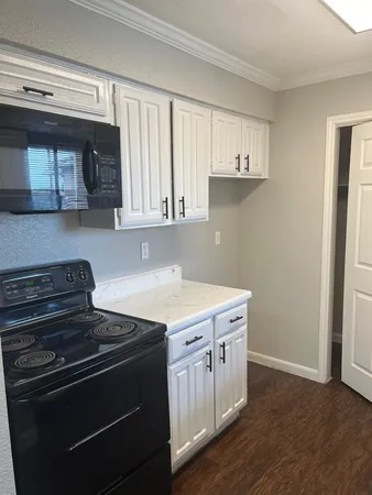 a kitchen with a stove and a microwave
