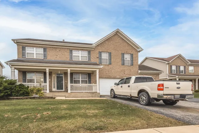 a white house covered with tall trees