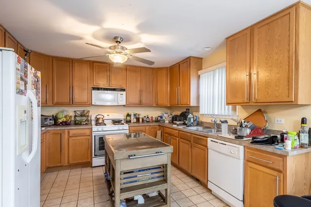 a kitchen with a sink a stove cabinets and counter space