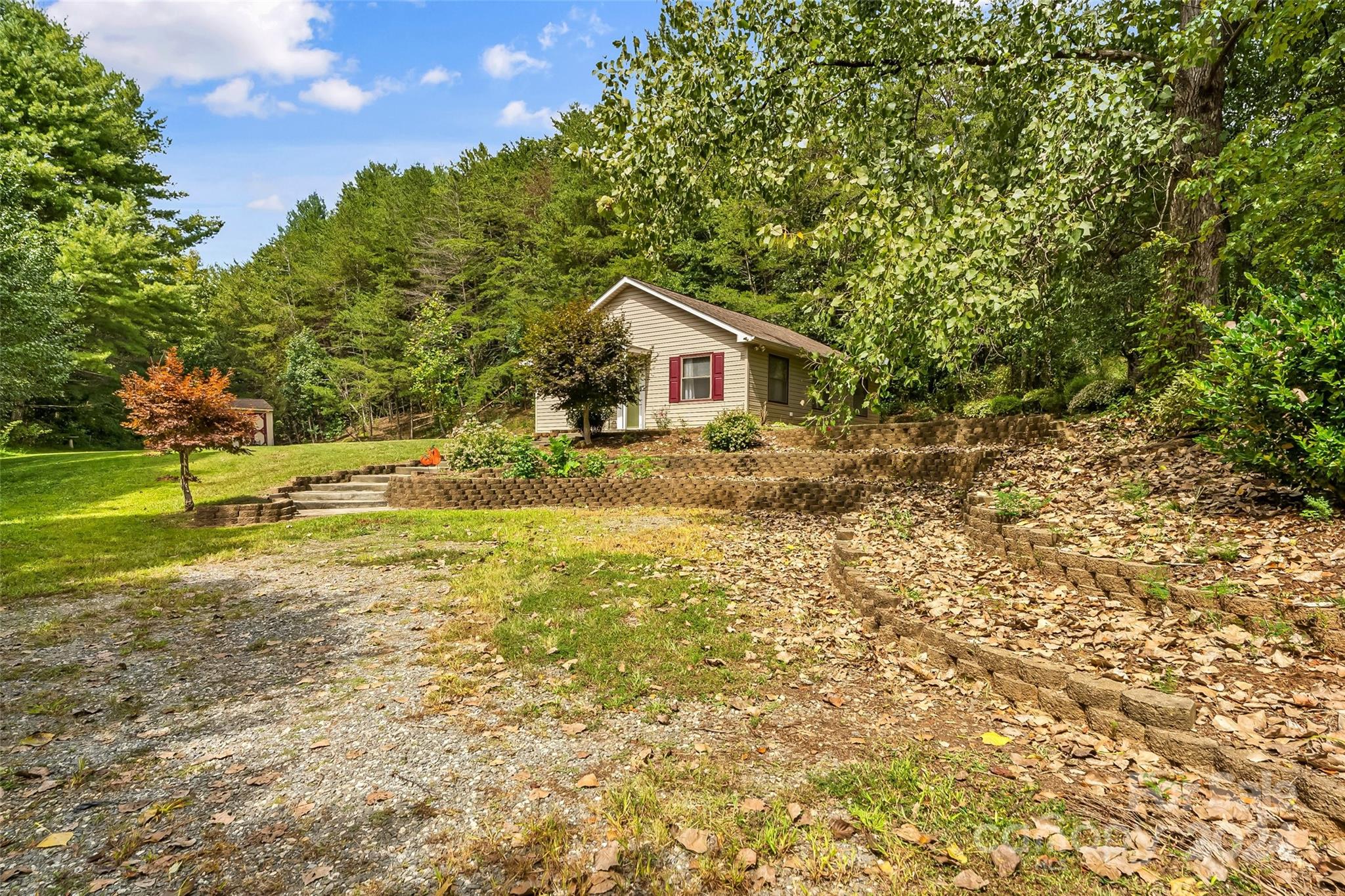 3840 Hide Away Hill Valdese, NC 28690 - Photo 1 of 21 a view of backyard with wooden fence and large trees