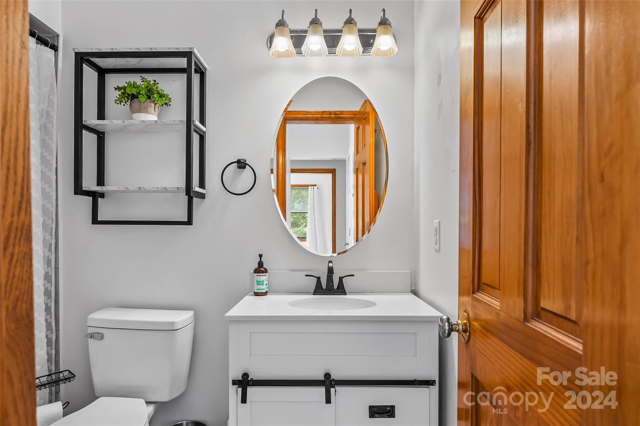 3840 Hide Away Hill Valdese, NC 28690 - Photo 15 of 21 a bathroom with a toilet sink and mirror