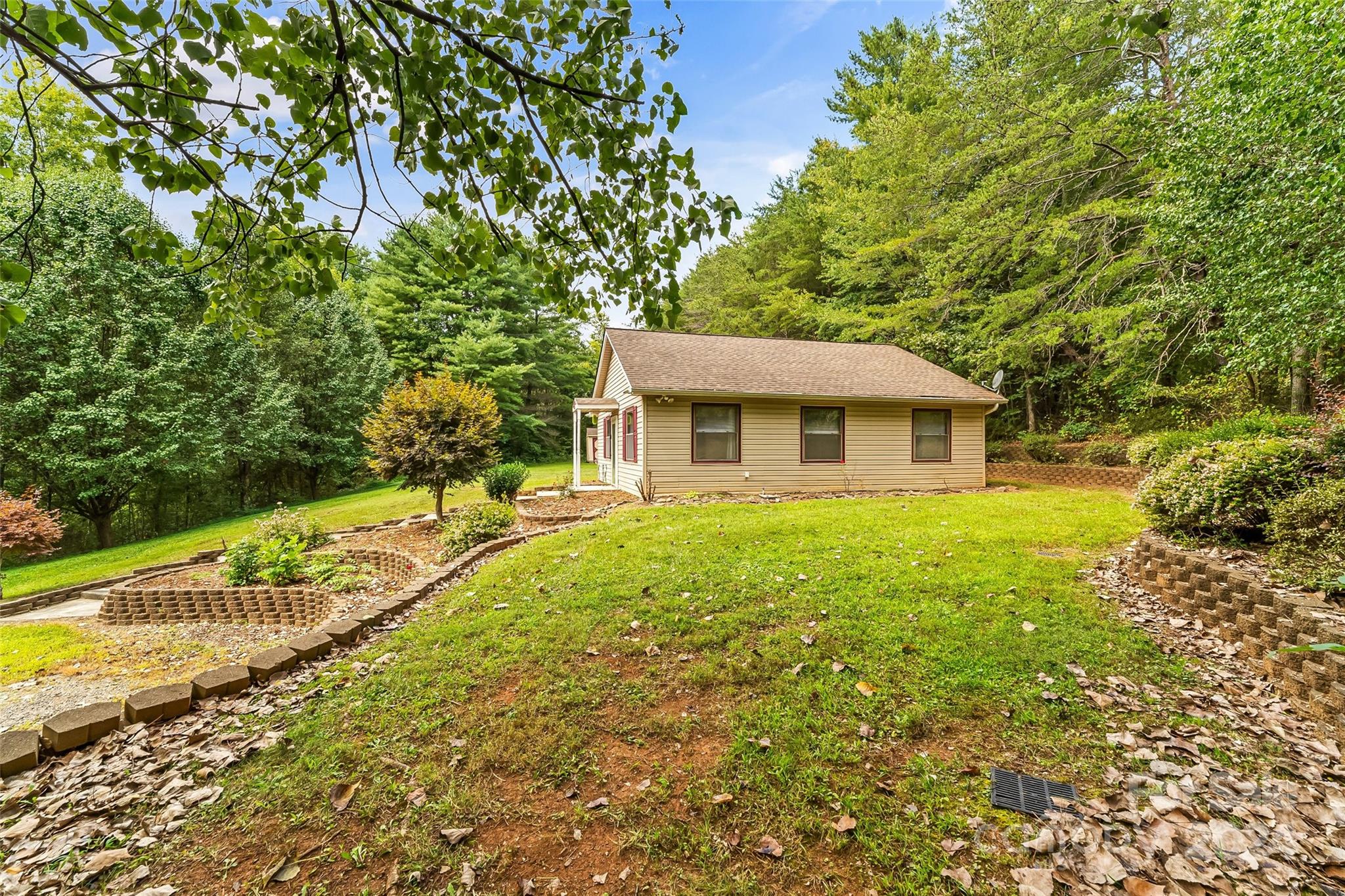 3840 Hide Away Hill Valdese, NC 28690 - Photo 4 of 21 a view of house with backyard and garden