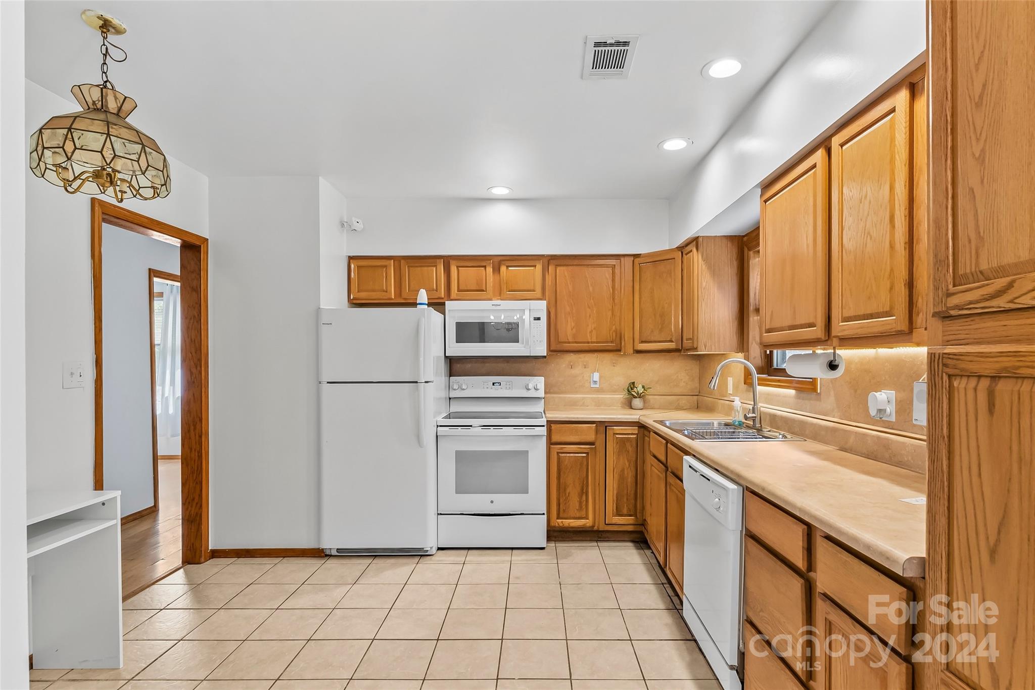 3840 Hide Away Hill Valdese, NC 28690 - Photo 9 of 21 a kitchen with stainless steel appliances granite countertop a refrigerator and a sink