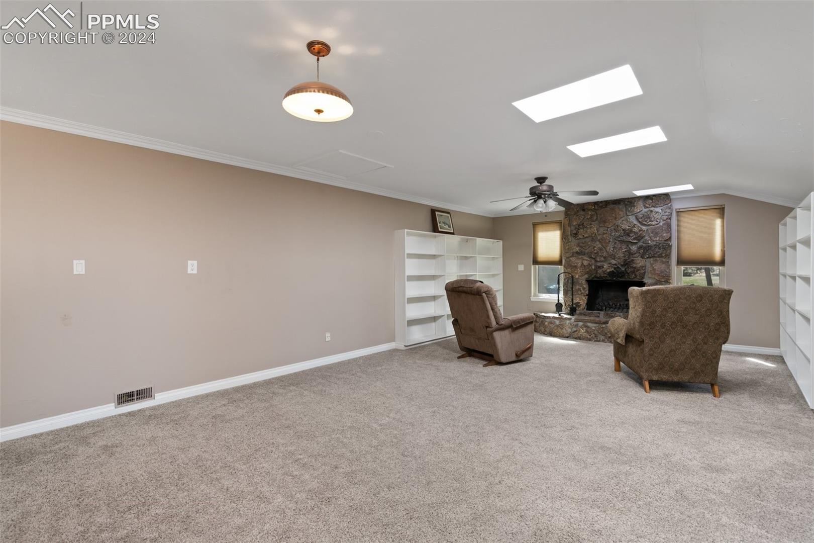 3830 Range View Road Monument, CO 80132 - Photo 40 of 50 Large family room/ library with wood burning fireplace which has a stone hearth and surround.