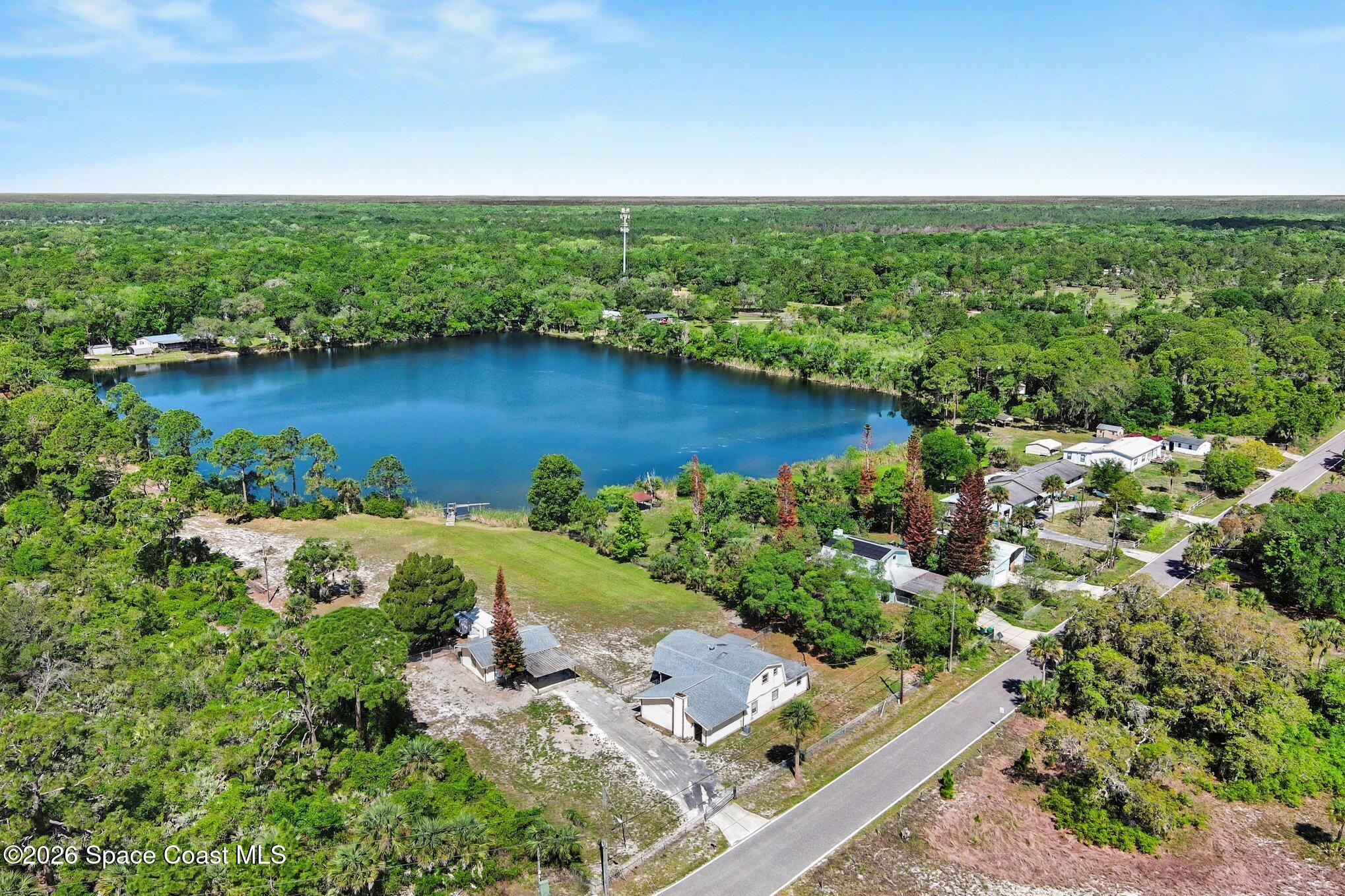 4950 Blounts Ridge Road Mims, FL 32754 - Photo 38 of 40 a view of a garden with a lake