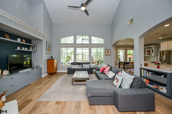a kitchen with stainless steel appliances kitchen island granite countertop a table chairs and a refrigerator