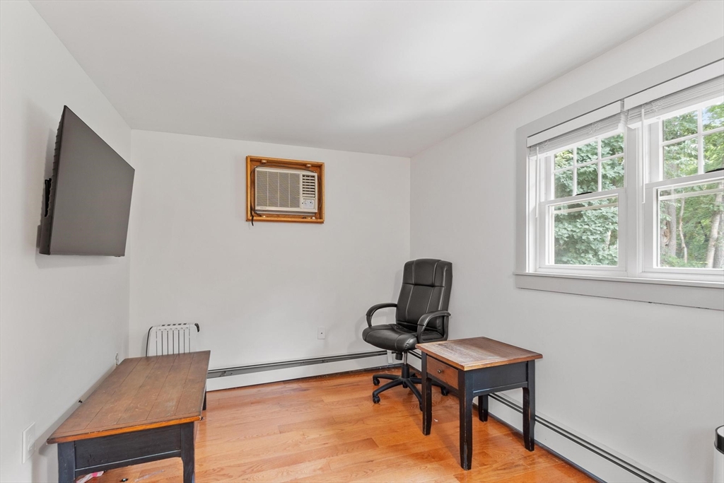 241 Reservoir Road Lunenburg, MA 01462 - Photo 37 of 40 a view of a workspace with furniture and a window
