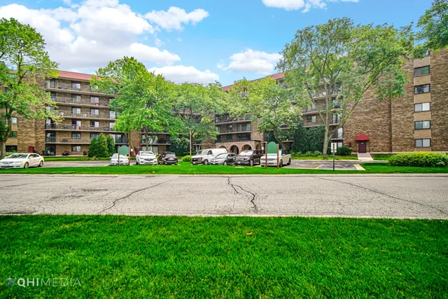 a green field with lots of trees in the background