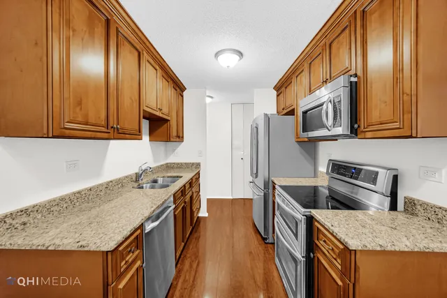 a kitchen with stainless steel appliances granite countertop a stove and a sink