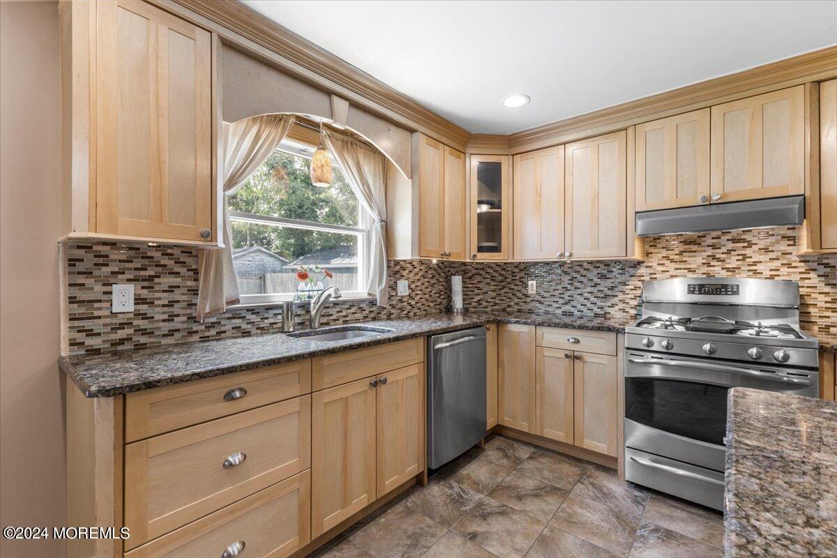 54 Metedeconk Road Brick, NJ 08723 - Photo 16 of 35 a kitchen with granite countertop a sink stainless steel appliances and cabinets