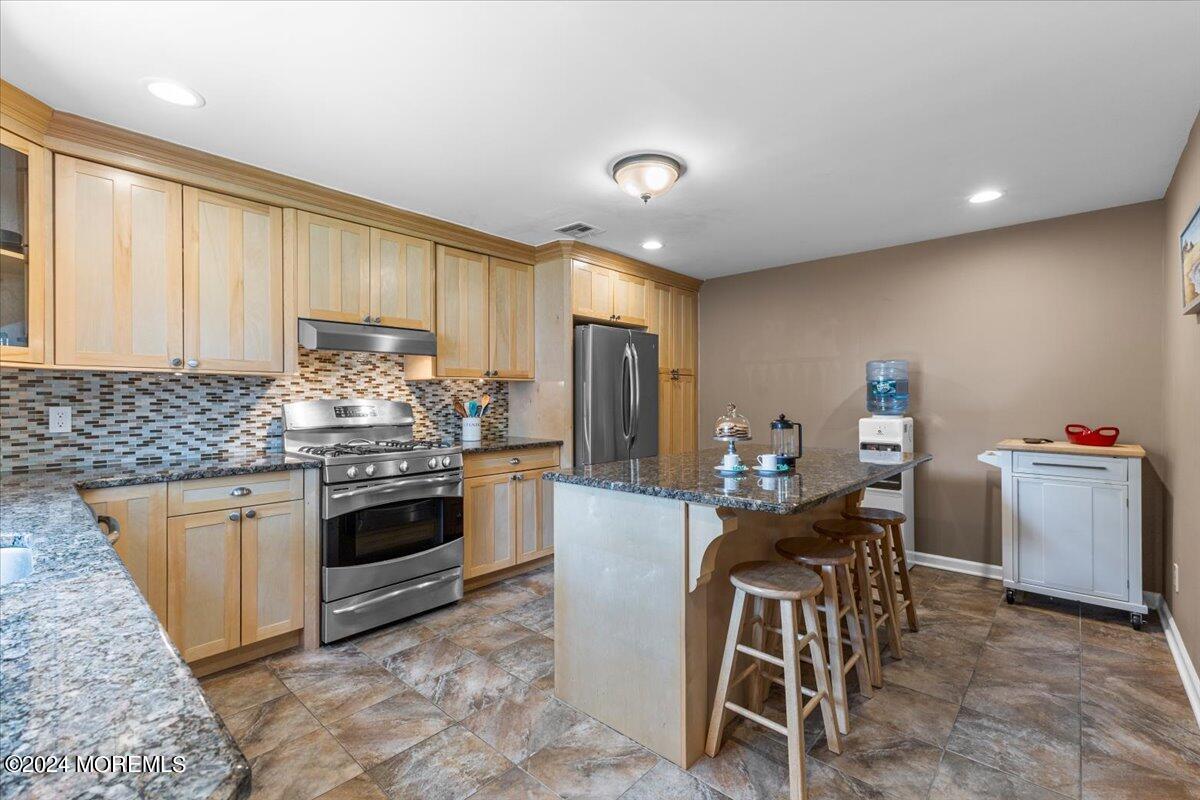54 Metedeconk Road Brick, NJ 08723 - Photo 17 of 35 a kitchen with sink a stove and chairs