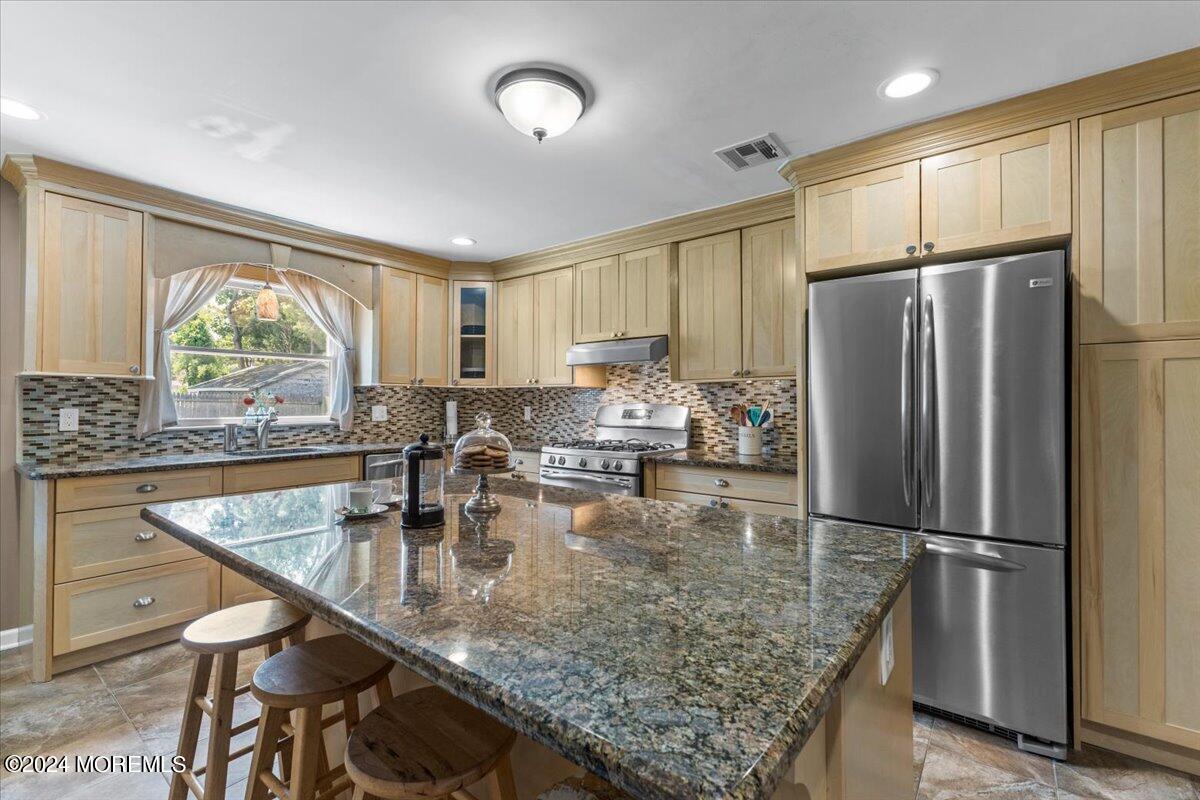 54 Metedeconk Road Brick, NJ 08723 - Photo 18 of 35 a kitchen with kitchen island granite countertop a stove refrigerator and microwave