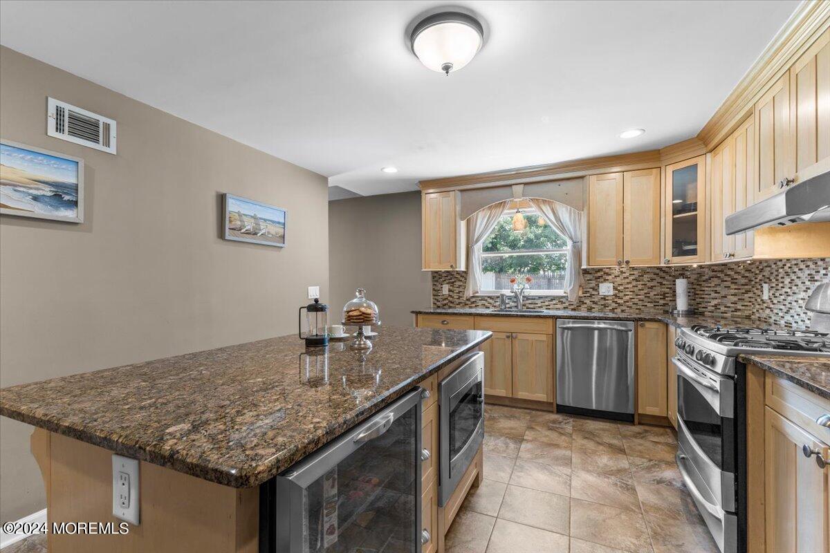 54 Metedeconk Road Brick, NJ 08723 - Photo 19 of 35 a kitchen with stainless steel appliances granite countertop a stove a sink and a microwave