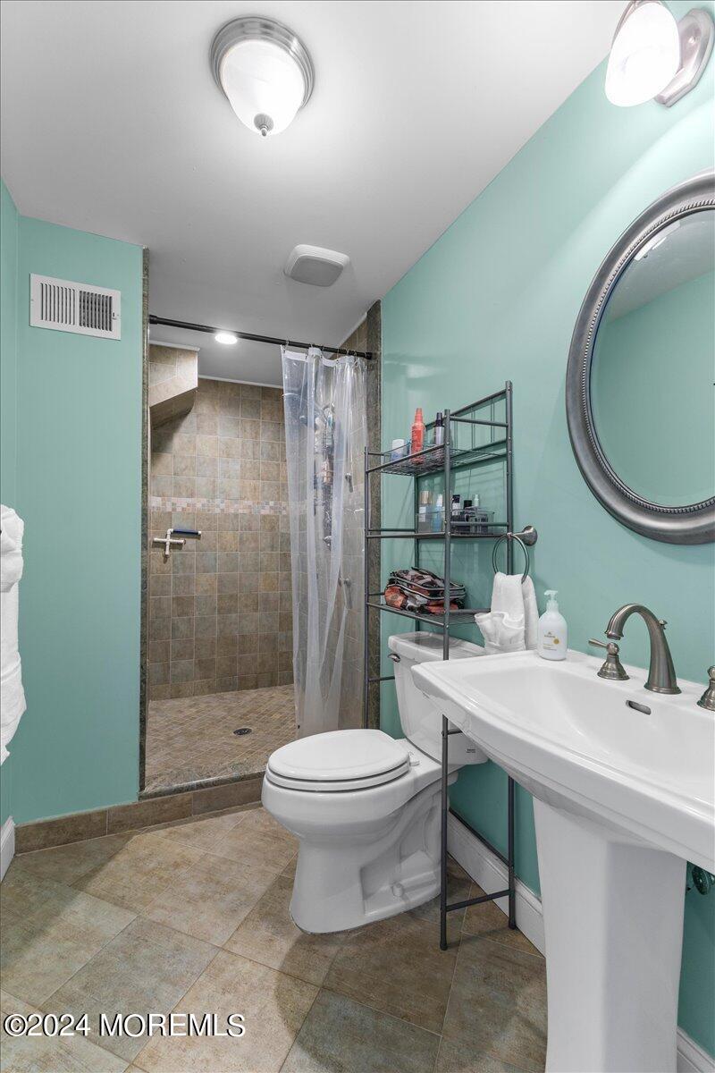 54 Metedeconk Road Brick, NJ 08723 - Photo 20 of 35 a bathroom with a sink toilet and shower