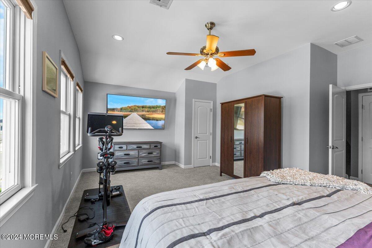 54 Metedeconk Road Brick, NJ 08723 - Photo 24 of 35 a bedroom with a bed and a chandelier