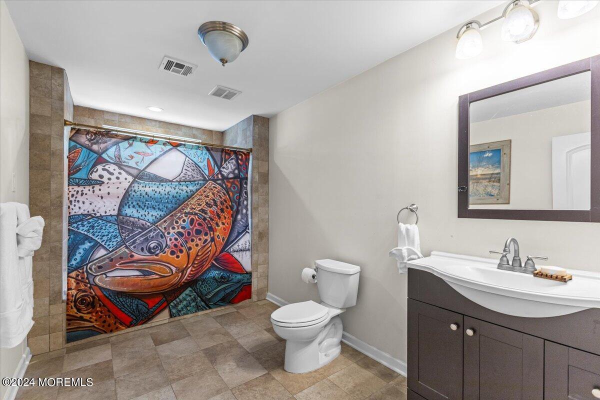 54 Metedeconk Road Brick, NJ 08723 - Photo 25 of 35 a bathroom with a sink mirror vanity and toilet