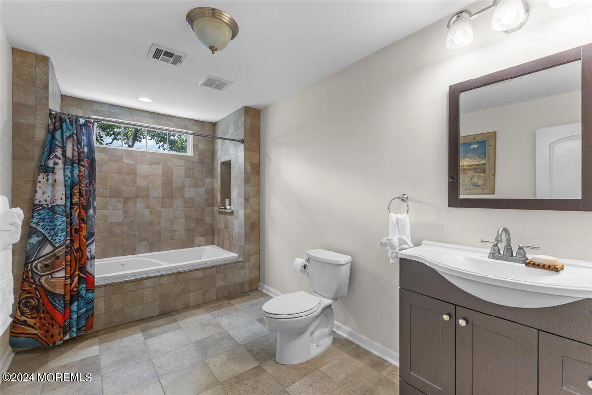 54 Metedeconk Road Brick, NJ 08723 - Photo 26 of 35 a bathroom with a sink a toilet and shower