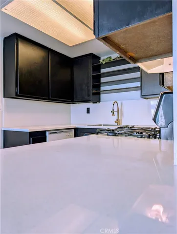 a kitchen with a refrigerator and microwave