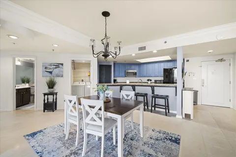 a kitchen with kitchen island granite countertop a sink stove microwave and refrigerator