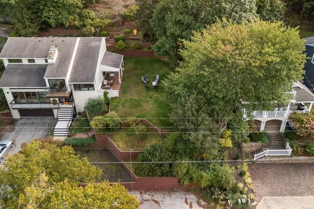 an aerial view of residential houses with outdoor space