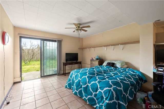 a bedroom with a bed and a television