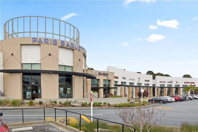 a view of building with a swimming pool and outdoor seating