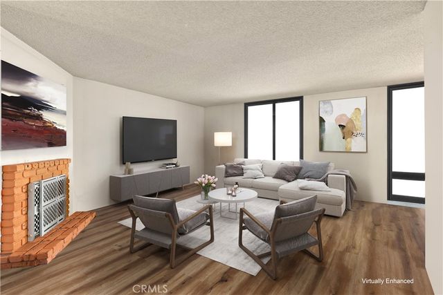 a living room with fireplace furniture and a flat screen tv