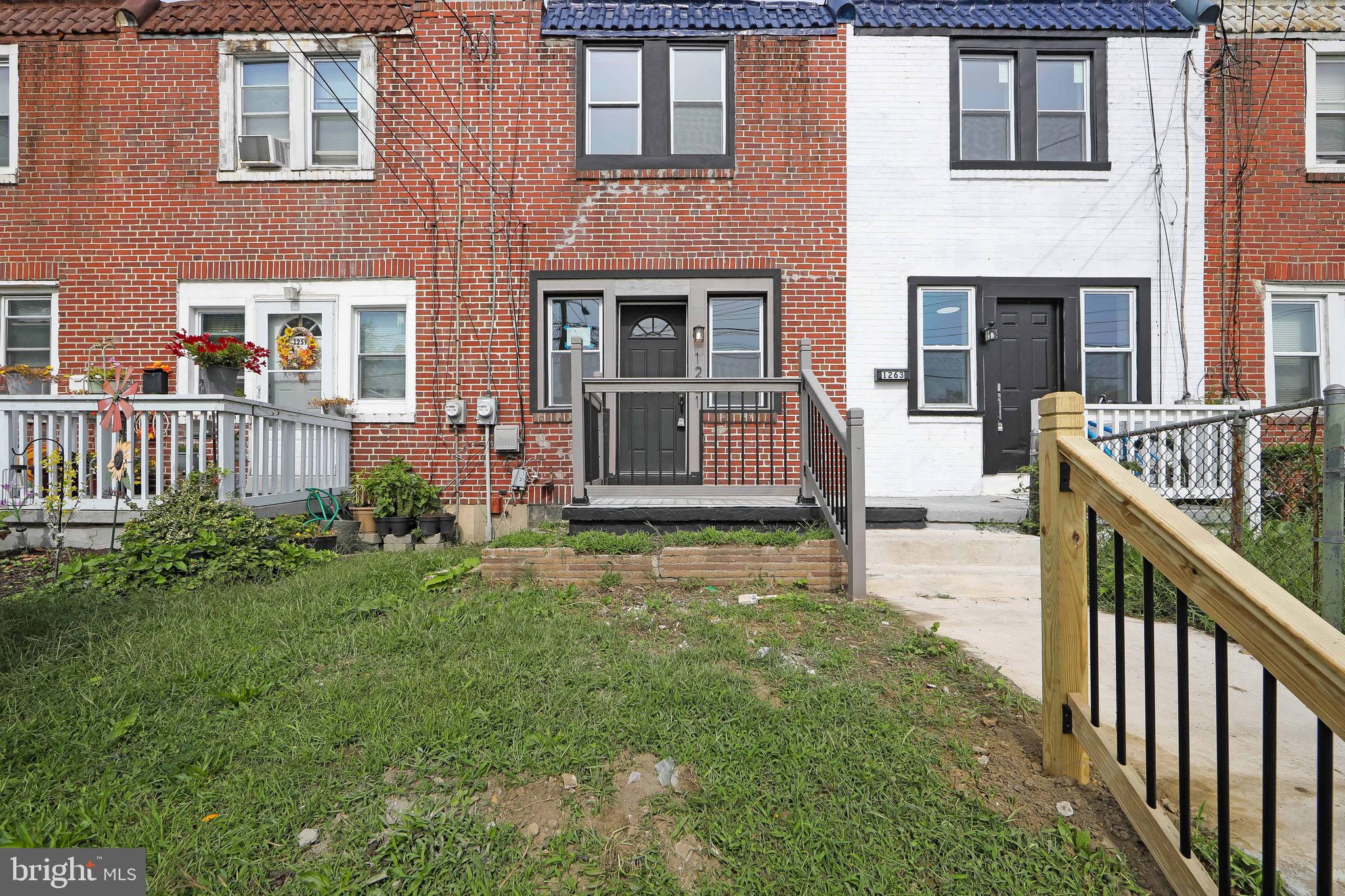 1261 South Merrimac Road Camden, NJ 08104 - Photo 1 of 27 a front view of a house with a garden