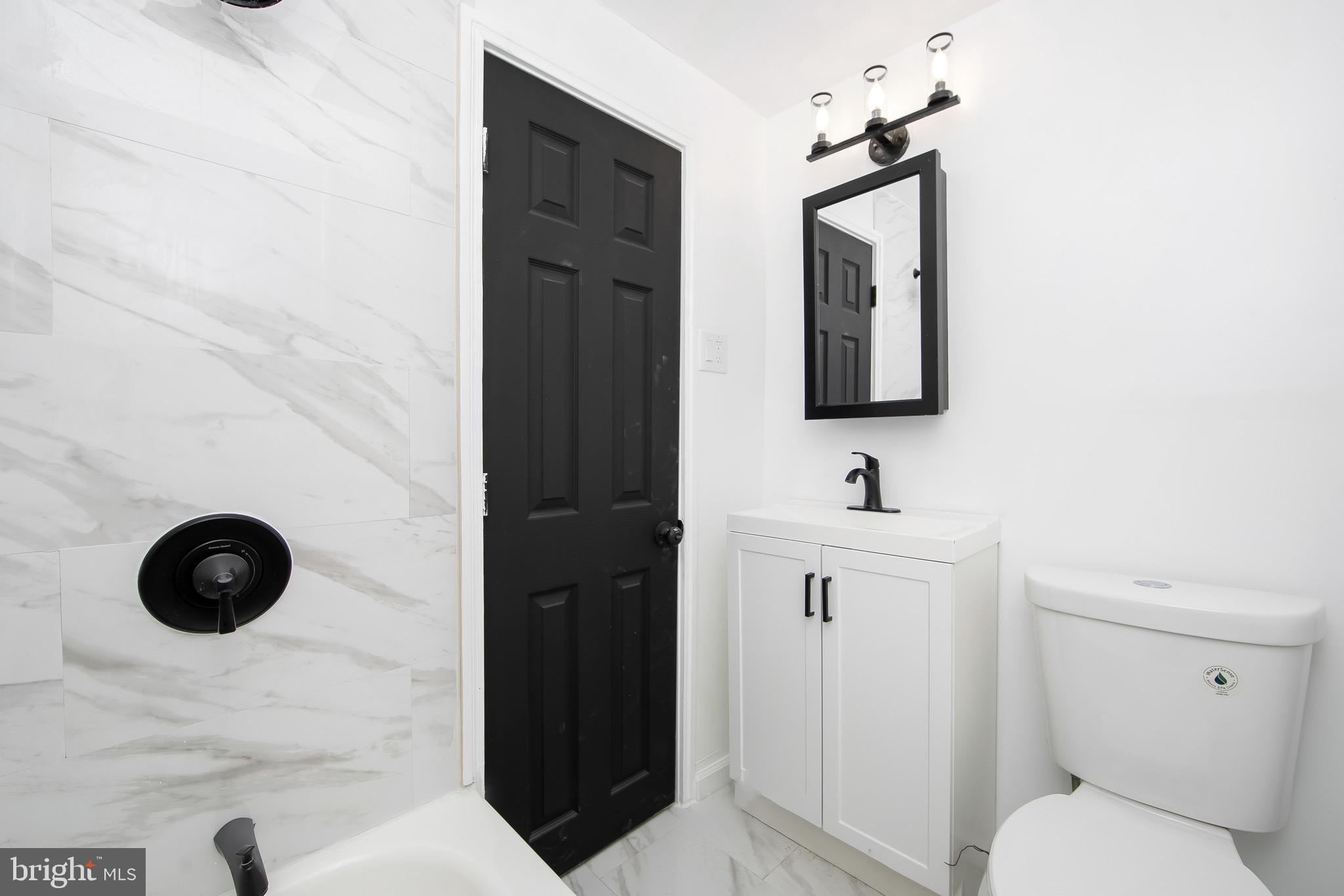 1261 South Merrimac Road Camden, NJ 08104 - Photo 15 of 27 a bathroom with a toilet sink and mirror