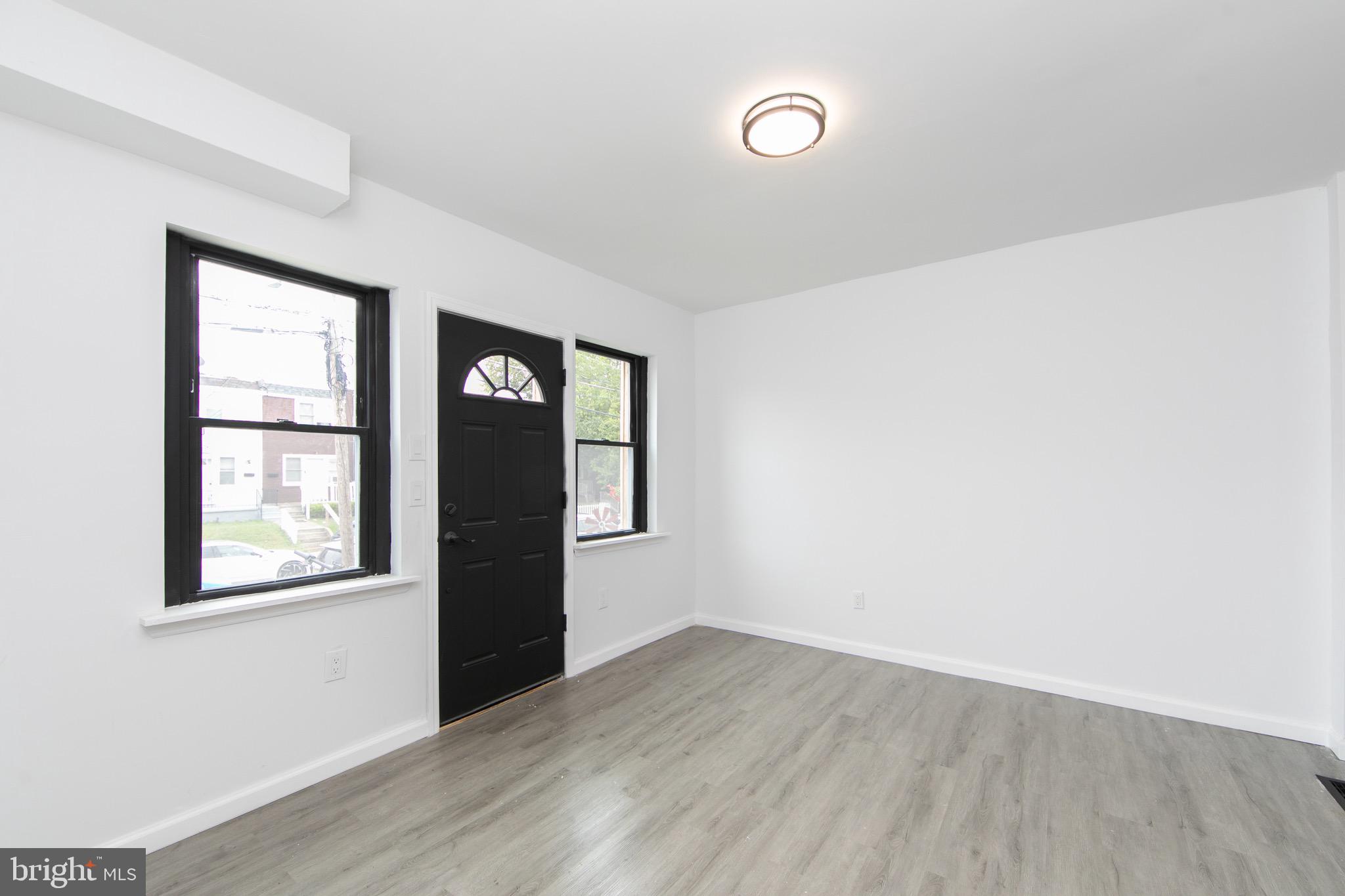 1261 South Merrimac Road Camden, NJ 08104 - Photo 4 of 27 an empty room with wooden floor and windows