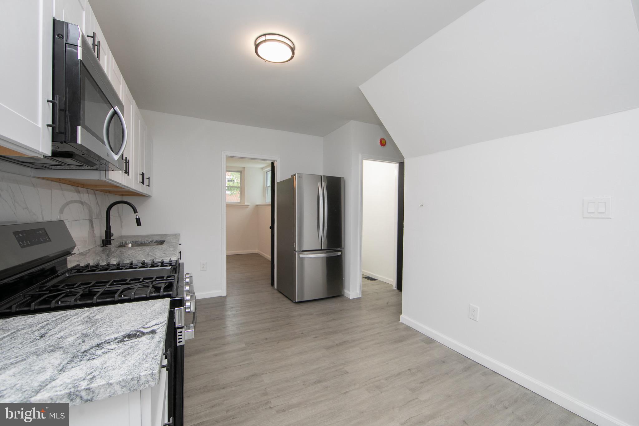 1261 South Merrimac Road Camden, NJ 08104 - Photo 5 of 27 a kitchen with stainless steel appliances granite countertop a refrigerator a stove a sink and dishwasher